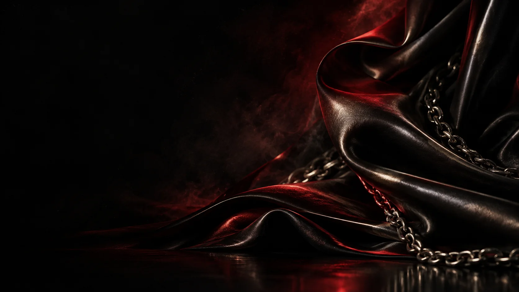 Sculptural folds of black silk lit by a deep crimson glow